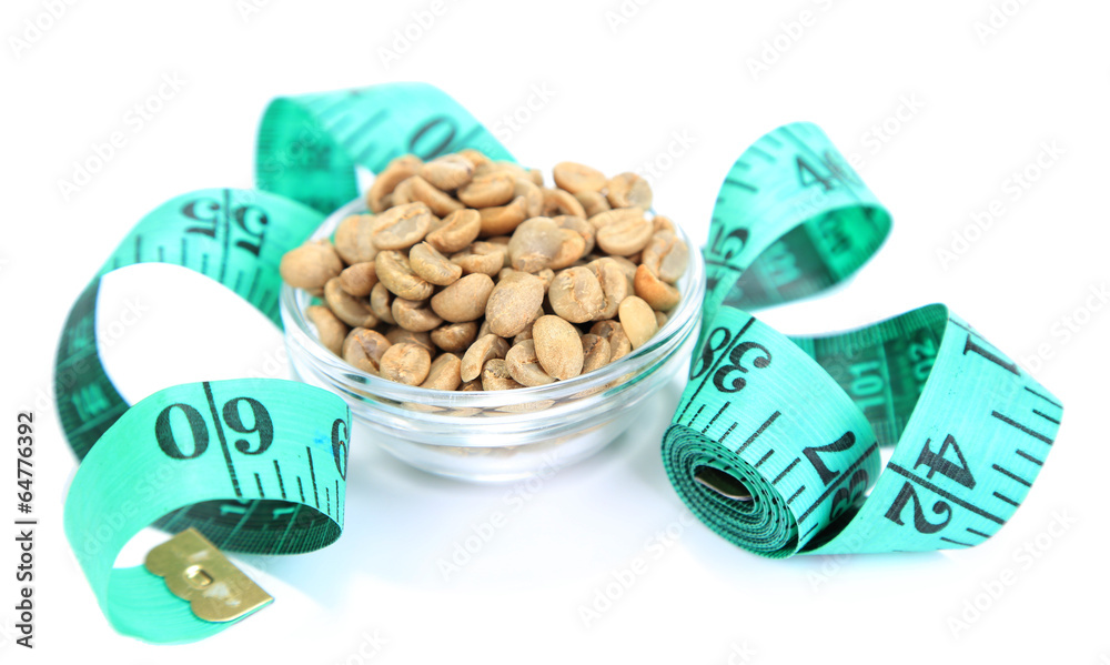 Raw green coffee beans and measuring tape, isolated