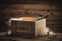 Bottle Of Wine In Box In Wooden Interior