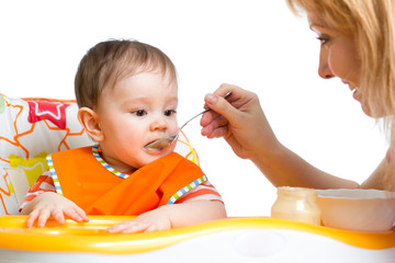 Wall Mural - baby eating food on kitchen