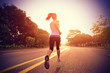Leinwandbild Motiv Runner athlete running on sunrise road