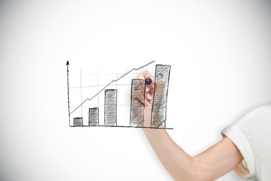 Composite image of businesswoman drawing graph