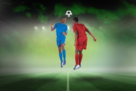 Football players tackling for the ball