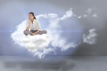Poster - Composite image of businesswoman sitting cross legged thinking