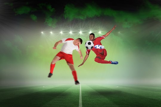 Football players tackling for the ball