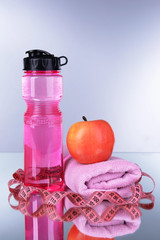 Canvas Print - Sports bottle, apple,towel and measuring tape on grey