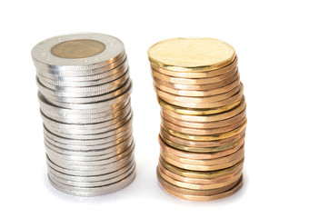 Silver and brass coins stack on white background