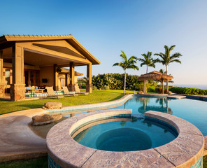 Luxury home with swimming pool at sunset