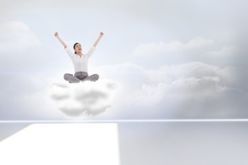 Poster - Composite image of cheering businesswoman sitting cross legged