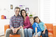 © jackfrog - family sitting on a sofa in her living room