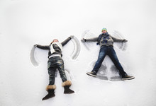 Boy And Girl Making Snow Angels