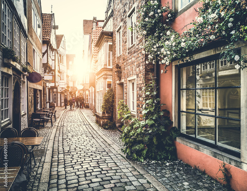 Naklejka dekoracyjna Historic street in Europe at sunset with retro vintage effect