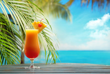 Refreshing Orange Cocktail On Beach Table.