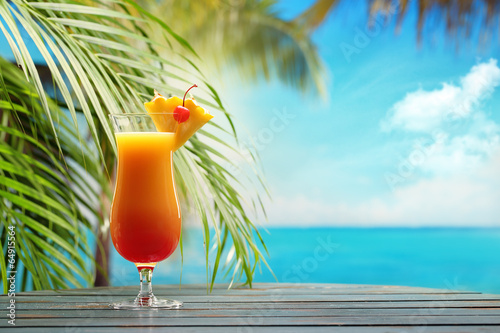 Fotografie, Obraz Refreshing orange cocktail on beach table.