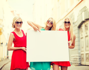 Canvas Print - three happy blonde women with blank white board