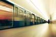 Motion blurred commuters  in subway station.