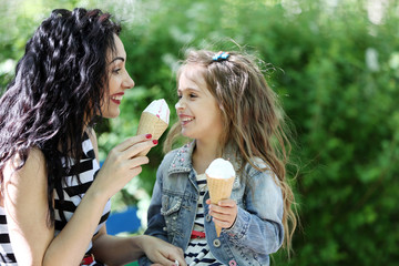 Happy mom and daughter. Walk in the green park