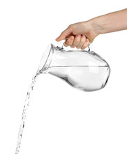 Pouring Water From Glass Pitcher, Isolated On White