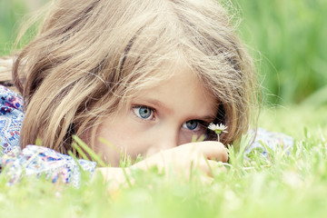 adorable girl lying on grass