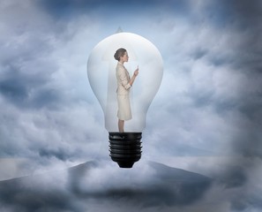 Aufkleber - Composite image of thinking businesswoman in light bulb