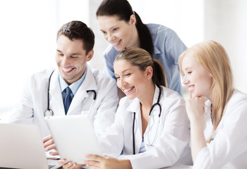 Canvas Print - group of doctors looking at tablet pc