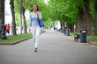© Andrey_Arkusha - Full length portrait of a beautiful woman in white pants and blu