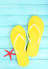 Sticker - Bright flip-flops on color wooden background