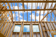 © leekris - New construction home framing against sky