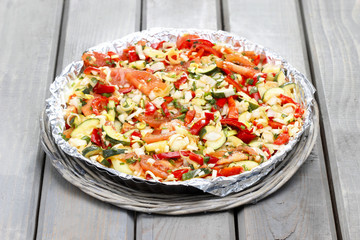 Canvas Print - Vegetable tart on rustic wooden table in the garden.