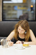© Maria Sbytova - Young woman working in a cafe