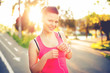 © aboutmomentsimages - Portrait of a smiling active female runner, resting from jogging