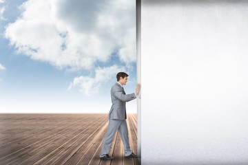 Poster - Composite image of businessman pushing away scene