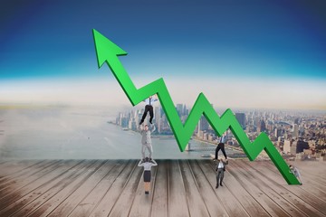 Poster - Composite image of business team holding up arrow