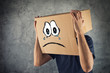 © Bits and Splits - Man with cardboard box on his head and sad face expression