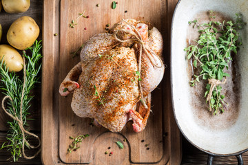 Preparing roast chicken with herbs