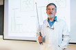 © lightpoet - Senior chemistry professor giving a lecture in front of class