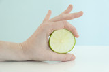 Fototapeta Mapy - Holding a slice of lime