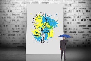 Poster - Composite image of businessman holding umbrella