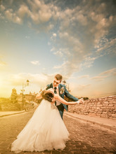 Groom And Bride Dancing On A Sunset Vintage Road
