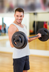 Poster - smiling man with barbell in gym