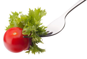 fresh salad and cherry tomato on fork isolated on white backgrou