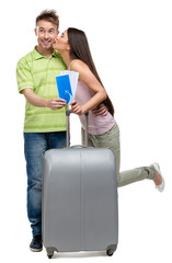 Wall Mural - Full-length portrait of embracing couple with suitcase 