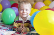 © natalinka29 - Smiling baby boy with colorful balloons.