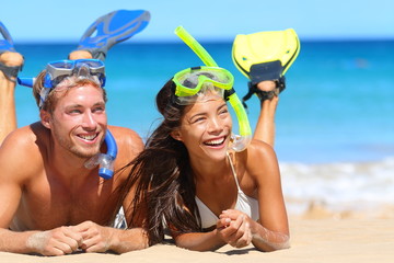 Beach travel couple having fun snorkeling