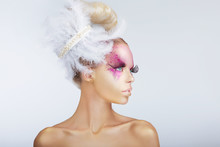 Creativity. Glamorous Fashion Model. Fancy Hair-do With Feathers