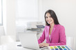 © jackfrog - beautiful businesswoman at office in front her laptop