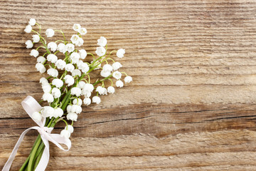 Sticker - Lily of the valley flowers on wooden background.