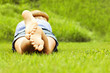 © Kalim - Woman lying on grass
