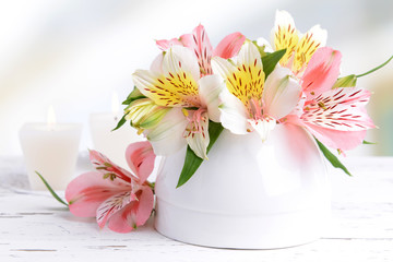 Wall Mural - Alstroemeria flowers in vase on table on light background