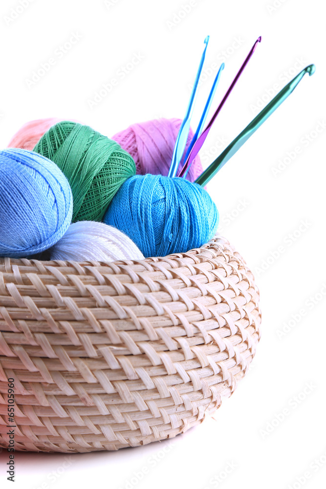 Colorful clews and crochet hooks in box isolated on white