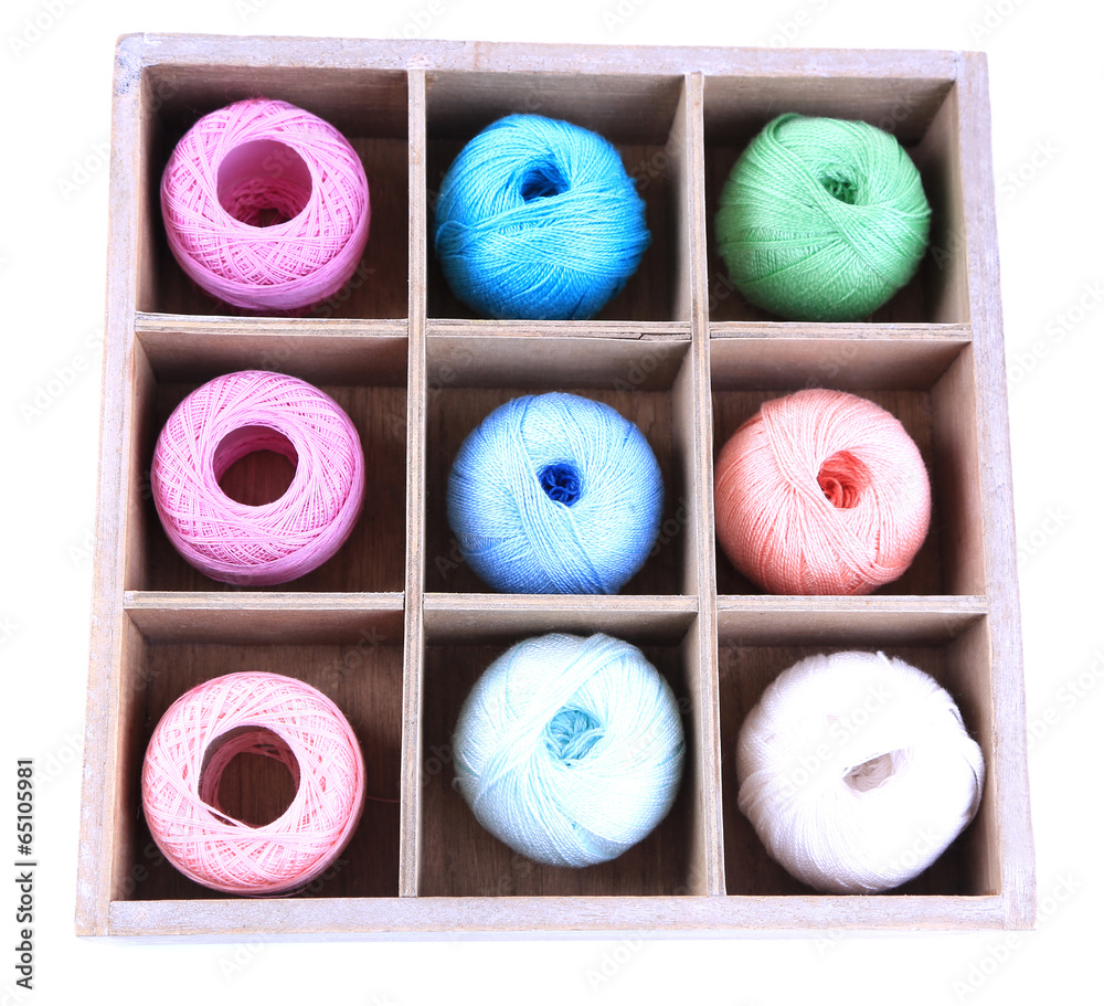 Colorful clews in wooden box isolated on white